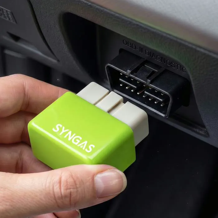 Close-up of the SynGas OBD2 fuel-saving device showing its compact plug-in connector
